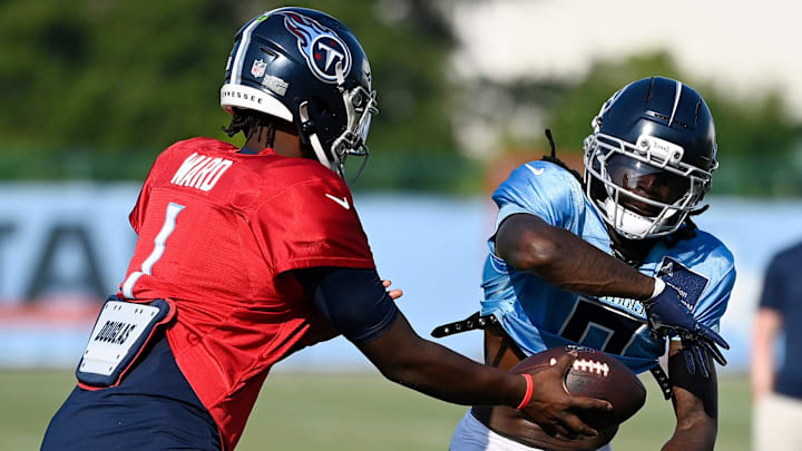 Tennessee Titans quarterback Cam Ward (1) hands the ball off to wide receiver Calvin Ridley (0) during an NFL football training camp practice at Ascension Saint Thomas Sports Park Saturday, Aug. 2, 2025, in Nashville, Tenn.