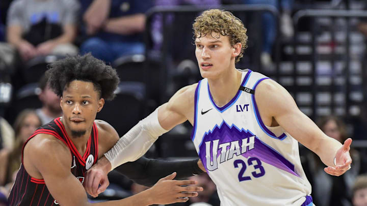 Nov 16, 2025; Salt Lake City, Utah, USA; Chicago Bulls forward/guard Isaac Okoro (35) looks to defend Utah Jazz forward/center Lauri Markkanen (23) during double overtime at Delta Center. Mandatory Credit: Peter Creveling-Imagn Images