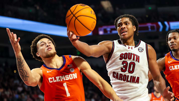Dec 17, 2024; Columbia, South Carolina, USA; South Carolina Gamecocks forward Collin Murray-Boyles (30) grabs a rebound in front of Clemson Tigers guard Chase Hunter (1) in the first half at Colonial Life Arena. Mandatory Credit: Jeff Blake-Imagn Images