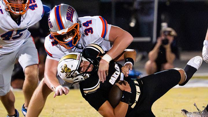 Bolles Bulldogs defensive lineman Asher Ghioto (34) tackles Oakleaf Knights Kashawn Murphy (90) in the second quarter Friday September 19, 2025 at Oakleaf High School in Oakleaf Plantation, Florida. The Bolles Bulldogs are 3-1 while the Oakleaf Knights are 4-0. Bolles lead 21-6 at the half. [Doug Engle/Florida Times-Union]