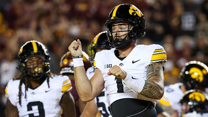 Sep 21, 2024; Minneapolis, Minnesota, USA; Iowa Hawkeyes quarterback Brendan Sullivan (1) celebrates his rushing touchdown against the Minnesota Golden Gophers during the second half at Huntington Bank Stadium. Mandatory Credit: Matt Krohn-Imagn Images