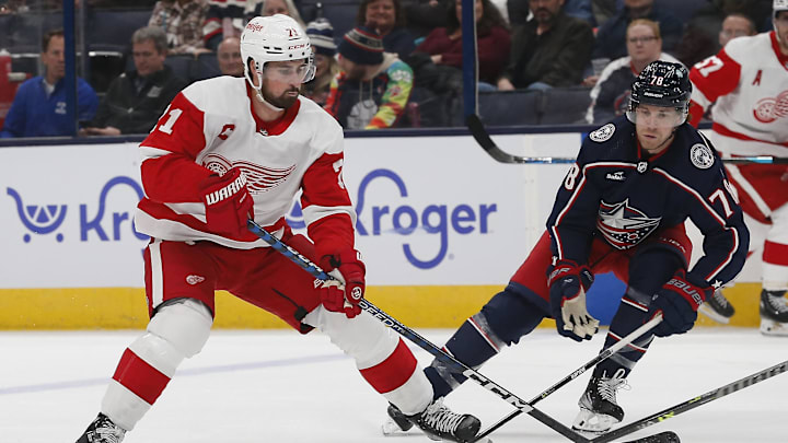 Oct 16, 2023; Columbus, Ohio, USA; Columbus Blue Jackets defenseman Damon Severson (78) defends against Detroit Red Wings center Dylan Larkin (71) during the first period at Nationwide Arena. Mandatory Credit: Russell LaBounty-Imagn Images
