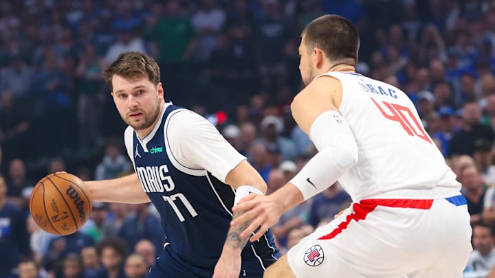 Apr 28, 2024; Dallas, Texas, USA;  Dallas Mavericks guard Luka Doncic (77) controls the ball as LA