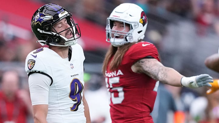 Oct 29, 2023; Glendale, Arizona, USA; Arizona Cardinals linebacker Dennis Gardeck (45) and Baltimore Ravens place kicker Justin Tucker (9) react after a missed field goal during the first half at State Farm Stadium. Mandatory Credit: Joe Camporeale-Imagn Images