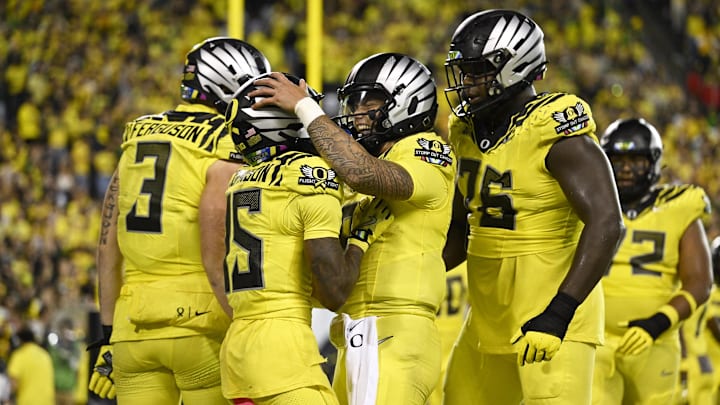 Oct 4, 2024; Eugene, Oregon, USA; Oregon Ducks wide receiver Tez Johnson (15), left, celebrates catching a touchdown pass with Oregon Ducks quarterback Dillon Gabriel (8) during the second half against the Michigan State Spartans at Autzen Stadium. Mandatory Credit: Troy Wayrynen-Imagn Images