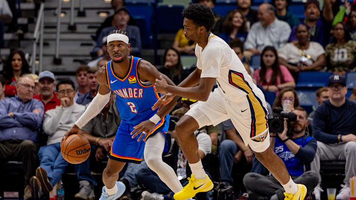 Nov 17, 2025; New Orleans, Louisiana, USA; Oklahoma City Thunder guard Shai Gilgeous-Alexander (2) dribbles against New Orleans Pelicans forward Herbert Jones (2) during the first half at Smoothie King Center. Mandatory Credit: Stephen Lew-Imagn Images