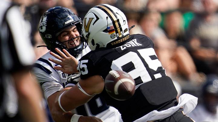 Utah State quarterback Bryson Barnes (16) tries to get the ball off under pressure from Vanderbilt defensive lineman Linus Zunk (95) during the third quarter at FirstBank Stadium in Nashville, Tenn., Saturday, Sept. 27, 2025.
