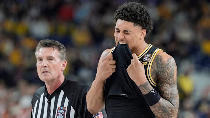 Michigan forward Yaxel Lendeborg (23) bites his jersey following a play in the first half of their Final Four game against Arizona at Lucas Oil Stadium in Indianapolis on Saturday, April 4, 2026.