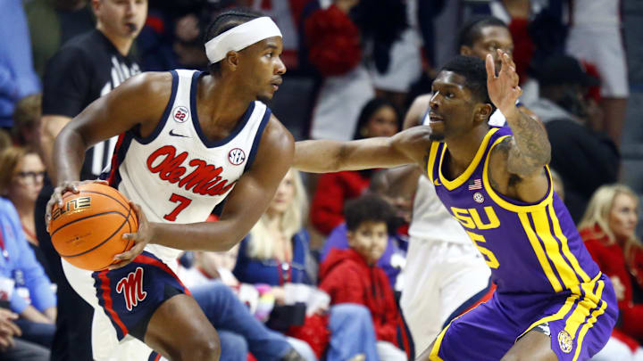 Jan 11, 2025; Oxford, Mississippi, USA; Mississippi Rebels guard Davon Barnes (7) handles the ball as LSU Tigers guard Cam Carter (5) defends during the first half at The Sandy and John Black Pavilion at Ole Miss. Mandatory Credit: Petre Thomas-Imagn Images