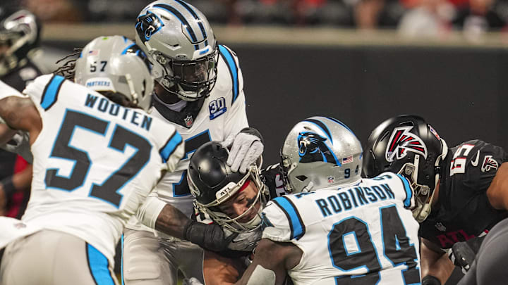 Jan 5, 2025; Atlanta, Georgia, USA; Atlanta Falcons running back Tyler Allgeier (25) is tackled by Carolina Panthers linebacker Jadeveon Clowney (7) and defensive end A'Shawn Robinson (94) during the first quarter at Mercedes-Benz Stadium. Mandatory Credit: Dale Zanine-Imagn Images Jan 5, 2025; Atlanta, Georgia, USA; Atlanta Falcons running back Tyler Allgeier (25) is tackled by Carolina Panthers linebacker Jadeveon Clowney (7) and defensive end A'Shawn Robinson (94) during the first quarter at Mercedes-Benz Stadium. Mandatory Credit: Dale Zanine-Imagn Images
