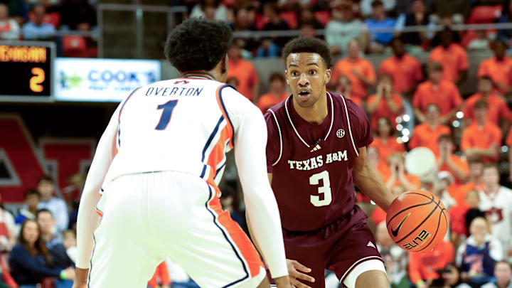 Dec 3, 2025; Auburn, Alabama, USA;  Texas A&M Aggies guard Rylan Griffen (3) runs a play as Auburn Tigers guard Kevin Overton (1) defends during the first half at Neville Arena. Mandatory Credit: John Reed-Imagn Images