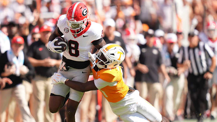 Tennessee defensive back Ty Redmond (4) grabs Georgia wide receiver Colbie Young (8) during an NCAA college football game on September 13, 2025, Knoxville, Tennessee.