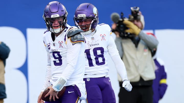 Dec 21, 2025; East Rutherford, New Jersey, USA; Minnesota Vikings quarterback J.J. McCarthy (9) reacts with wide receiver Justin Jefferson (18) after rushing for a touchdown against the New York Giants during the first half at MetLife Stadium.