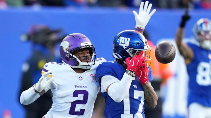 Dec 21, 2025; East Rutherford, New Jersey, USA; New York Giants wide receiver Wan'Dale Robinson (17) attempts to make a catch against Minnesota Vikings cornerback Isaiah Rodgers (2) during the first half at MetLife Stadium. Mandatory Credit: Robert Deutsch-Imagn Images