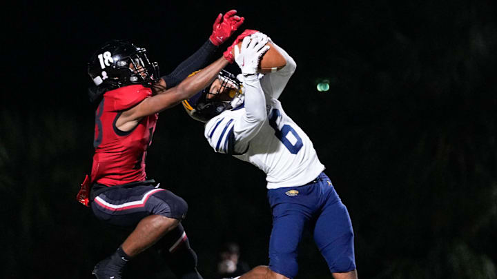 Naples Golden Eagles defensive back Andre Ferdinand (6) intercepts a pass from Port Charlotte Pirates quarterback Logan Flaherty (17) during the fourth quarter of the Class 4A Region 3 championship at Port Charlotte High School in Port Charlotte, Fla., on Friday, Nov. 29, 2024. Naples was able to run out the clock after the turnover. Naples Golden Eagles defensive back Andre Ferdinand (6) intercepts a pass from Port Charlotte Pirates quarterback Logan Flaherty (17) during the fourth quarter of the Class 4A Region 3 championship at Port Charlotte High School in Port Charlotte, Fla., on Friday, Nov. 29, 2024. Naples was able to run out the clock after the turnover.
