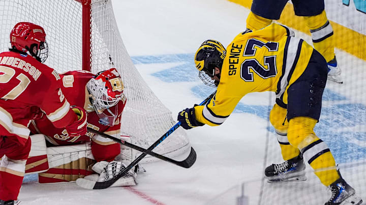 Michigan forward Malcolm Spence (27) tries to score against Denver goaltender Johnny Hicks (31) during the second period of the Frozen Four semifinal at T-Mobile Arena in Las Vegas on Thursday, April 9, 2026