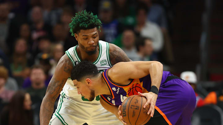 Dec 7, 2022; Phoenix, Arizona, USA; Boston Celtics guard Marcus Smart (36) against Phoenix Suns guard Devin Booker (1) at Footprint Center. Mandatory Credit: Mark J. Rebilas-Imagn Images