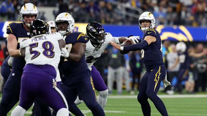 Nov 26, 2023; Inglewood, California, USA; Baltimore Ravens linebacker Jadeveon Clowney (24) forces a fumble by Los Angeles Chargers quarterback Justin Herbert (10) during the fourth quarter at SoFi Stadium. Mandatory Credit: Kiyoshi Mio-USA TODAY Sports