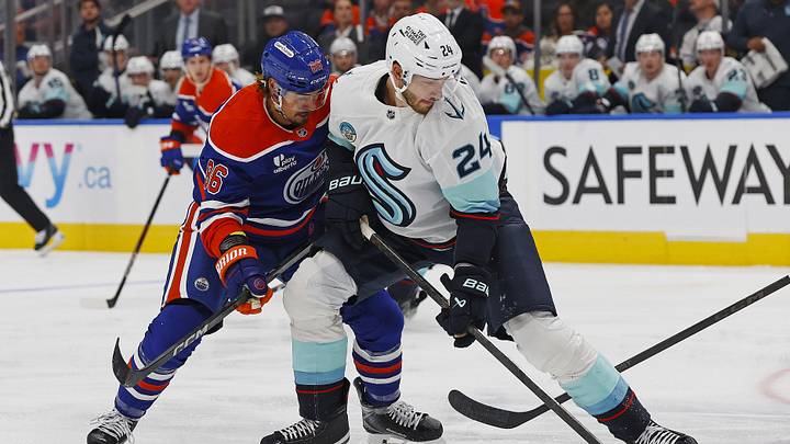 Sep 24, 2025; Edmonton, Alberta, CAN; Edmonton Oilers forward David Tomasek (86) and Seattle Kraken defensemen Jamie Oleksiak (24) battle for a loose puck during the first period at Rogers Place. Mandatory Credit: Perry Nelson-Imagn Images