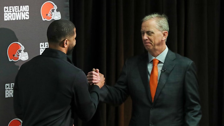 New Cleveland Browns head coach Todd Monken, facing, shakes hands with general manager Andrew Berry as he takes the podium for his introductory press conference at the team's training facility, Feb. 3, 2026.