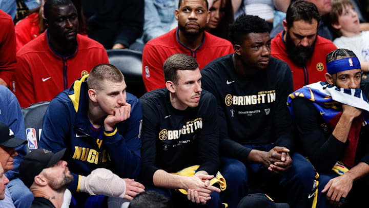 Apr 16, 2023; Denver, Colorado, USA; Denver Nuggets center Nikola Jokic (15) sits with his wrist wrapped next to forward Vlatko Cancar (31) and center Thomas Bryant (13) on the bench after fouling out in the fourth quarter against the Minnesota Timberwolves during game one of the 2023 NBA Playoffs at Ball Arena. Mandatory Credit: Isaiah J. Downing-Imagn Images