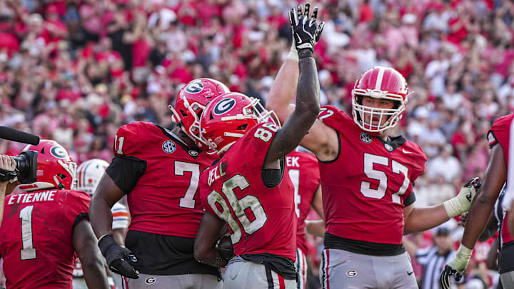 Oct 5, 2024; Athens, Georgia, USA; Georgia Bulldogs wide receiver Dillon Bell (86) reacts with offensive lineman Monroe Freeling (57) after catching a touchdown pass against the Auburn Tigers during the second half at Sanford Stadium. Mandatory Credit: Dale Zanine-Imagn Images
