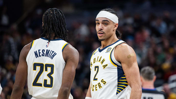Feb 1, 2025; Indianapolis, Indiana, USA; Indiana Pacers guard Andrew Nembhard (2) celebrates with forward Aaron Nesmith (23) after a foul and basket against the Atlanta Hawks in the second half at Gainbridge Fieldhouse. Mandatory Credit: Trevor Ruszkowski-Imagn Images