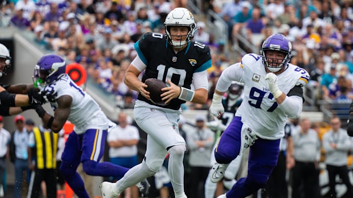 Nov 10, 2024; Jacksonville, Florida, USA; Jacksonville Jaguars quarterback Mac Jones (10) runs the ball against Minnesota Vikings defensive lineman Harrison Phillips (97) in the second quarter at EverBank Stadium.