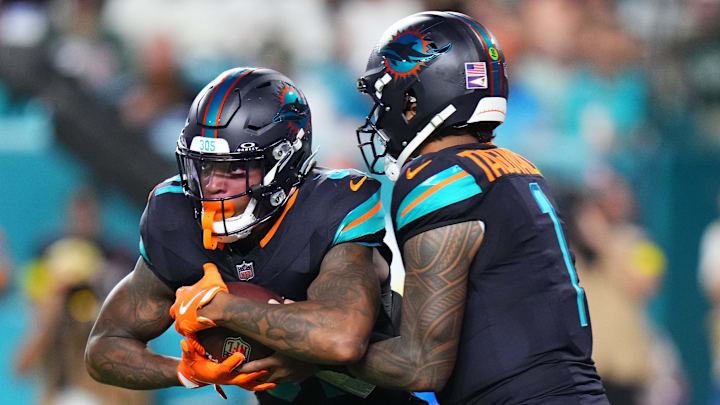 Sep 29, 2025; Miami Gardens, Florida, USA; Miami Dolphins quarterback Tua Tagovailoa (1) hands the ball off to running back Ollie Gordon II (31) against the New York Jets during the first half at Hard Rock Stadium. Mandatory Credit: Rich Storry-Imagn Images