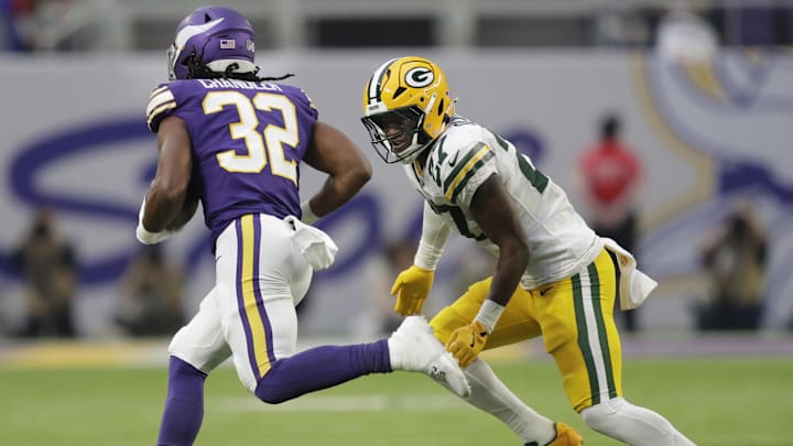 Jan 4, 2026; Minneapolis, Minnesota, USA;  Green Bay Packers safety Kitan Oladapo (27) pursues Minnesota Vikings running back Ty Chandler (32) at U.S. Bank Stadium. Mandatory Credit: Jeffrey Becker-Imagn Images