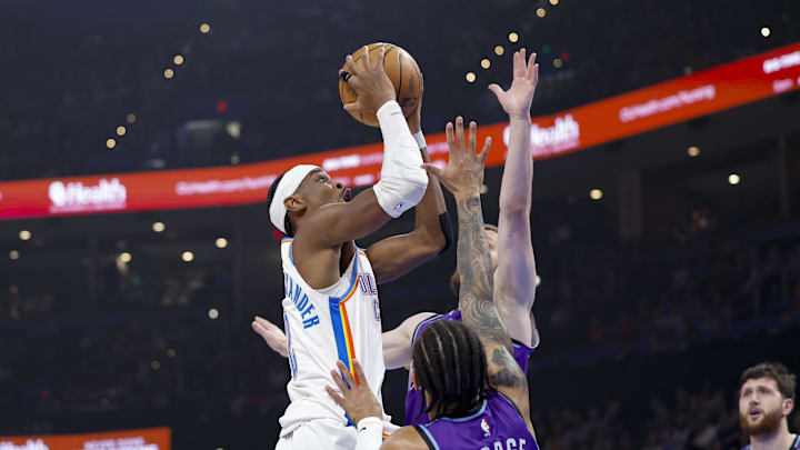 Jan 7, 2026; Oklahoma City, Oklahoma, USA; Oklahoma City Thunder guard Shai Gilgeous-Alexander (2) goes up for a basket as Utah Jazz guard Keyonte George (3) defends during the first quarter at Paycom Center. Mandatory Credit: Alonzo Adams-Imagn Images
