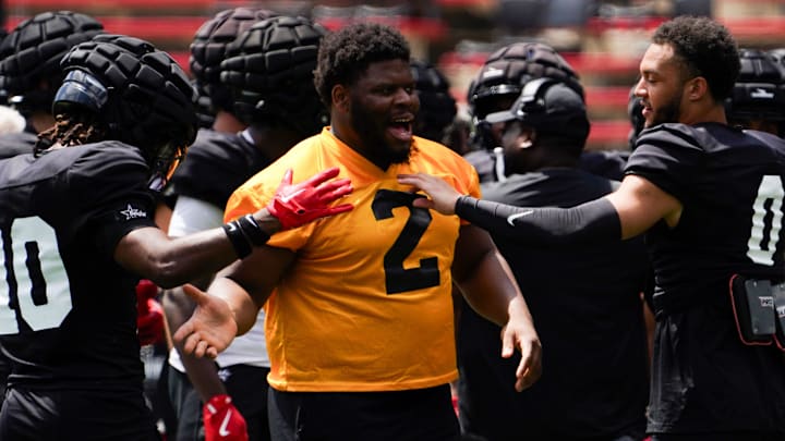 Cincinnati Bearcats defensive tackle Dontay Corleone (2) embraces his teammates during a scrimmage, Saturday, Aug. 10, 2024, at Nippert Stadium in Cincinnati. Cincinnati Bearcats defensive tackle Dontay Corleone (2) embraces his teammates during a scrimmage, Saturday, Aug. 10, 2024, at Nippert Stadium in Cincinnati.