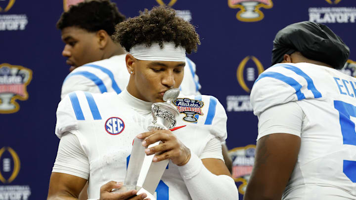 Jan 1, 2026; New Orleans, LA, USA; Mississippi Rebels quarterback Trinidad Chambliss (6) kisses the MVP trophy after the 2025 Sugar Bowl and quarterfinal game of the College Football Playoff against the Georgia Bulldogs at Caesars Superdome. Mandatory Credit: Amber Searls-Imagn Images Jan 1, 2026; New Orleans, LA, USA; Mississippi Rebels quarterback Trinidad Chambliss (6) kisses the MVP trophy after the 2025 Sugar Bowl and quarterfinal game of the College Football Playoff against the Georgia Bulldogs at Caesars Superdome. Mandatory Credit: Amber Searls-Imagn Images