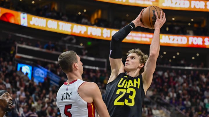Dec 31, 2022; Salt Lake City, Utah, USA; Utah Jazz forward/center Lauri Markkanen (23) bumps into Miami Heat forward Nikola Jovic (5) before a shot during the second half at Vivint Arena. Mandatory Credit: Christopher Creveling-USA TODAY Sports
