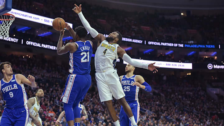 Mar 26, 2018; Philadelphia, PA, USA; Philadelphia 76ers center Joel Embiid (21) and Denver Nuggets forward Paul Millsap (4) jump for a rebound during the third quarter of the game at the Wells Fargo Center. The Philadelphia 76ers won the game 123-104. Mandatory Credit: John Geliebter-Imagn Images Mar 26, 2018; Philadelphia, PA, USA; Philadelphia 76ers center Joel Embiid (21) and Denver Nuggets forward Paul Millsap (4) jump for a rebound during the third quarter of the game at the Wells Fargo Center. The Philadelphia 76ers won the game 123-104. Mandatory Credit: John Geliebter-Imagn Images