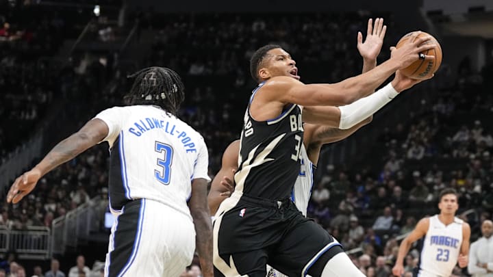 Milwaukee Bucks forward Giannis Antetokounmpo (34) drives for the basket past Orlando Magic guard Kentavious Caldwell-Pope (3) during the first quarter at Fiserv Forum.