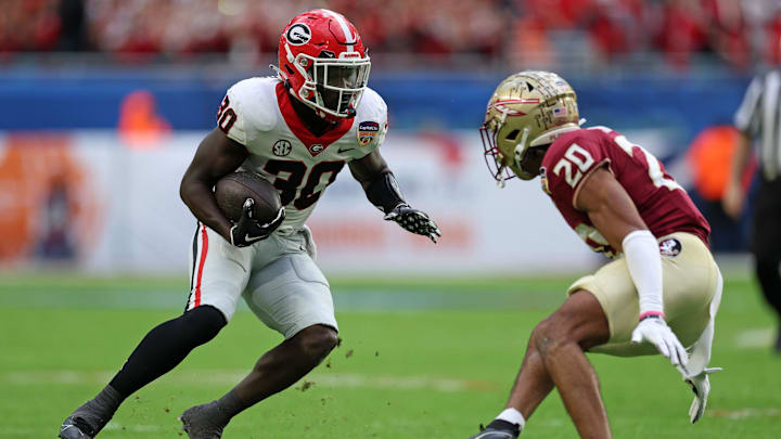 Dec 30, 2023; Miami Gardens, FL, USA; Georgia Bulldogs running back Daijun Edwards (30) rushes the ball against the Florida State Seminoles during the first half in the 2023 Orange Bowl at Hard Rock Stadium. Mandatory Credit: Nathan Ray Seebeck-Imagn Images