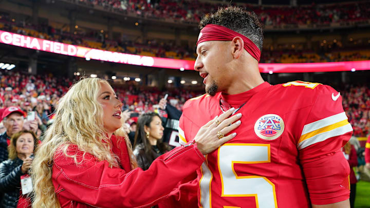 Oct 27, 2025; Kansas City, Missouri, USA; Kansas City Chiefs quarterback Patrick Mahomes (15) greets wife, Brittany Mahomes, during warmups prior to the game against the Washington Commanders at GEHA Field at Arrowhead Stadium. Mandatory Credit: Denny Medley-Imagn Images