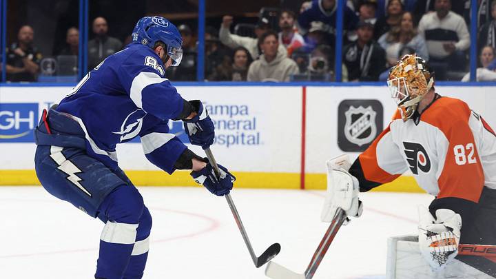 Mar 17, 2025; Tampa, Florida, USA;  Tampa Bay Lightning right wing Nikita Kucherov (86) shoots and scores a goal on Philadelphia Flyers goaltender Ivan Fedotov (82) during the first period at Amalie Arena. Mandatory Credit: Kim Klement Neitzel-Imagn Images