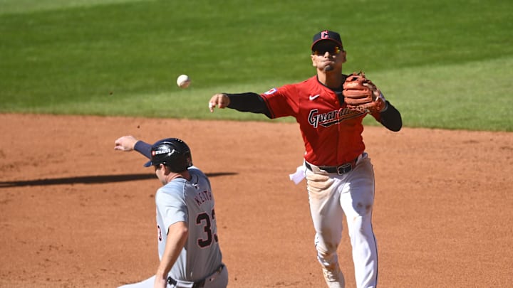 Oct 5, 2024; Cleveland, Ohio, USA; Cleveland Guardians second baseman Andres Gimenez (0) turns a double play over Detroit Tigers second baseman Colt Keith (33) in the fourth inning in game one of the ALDS for the 2024 MLB Playoffs at Progressive Field.