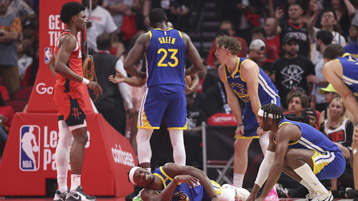 Apr 23, 2025; Houston, Texas, USA; Golden State Warriors forward Jimmy Butler III (10) suffers an apparent injury during the first quarter during game two of the first round for the 2024 NBA Playoffs against the Houston Rockets at Toyota Center. Mandatory Credit: Troy Taormina-Imagn Images