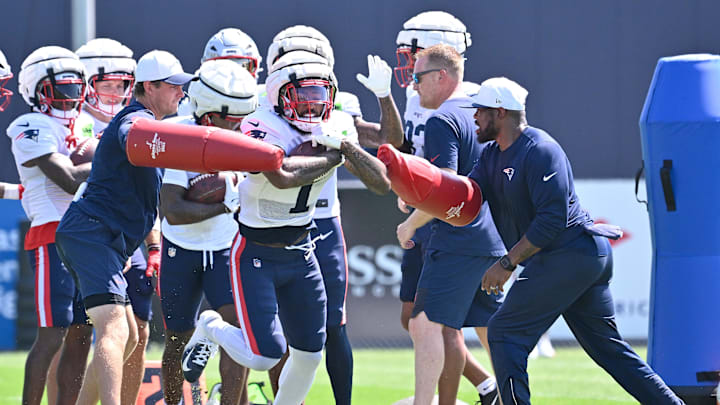 Jul 28, 2025; Foxborough, MA, USA; New England Patriots wide receiver Ja'Lynn Polk (1) works with coaching staff during training camp at Gillette Stadium. Mandatory Credit: Eric Canha-Imagn Images