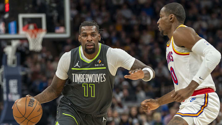 Minnesota Timberwolves center Naz Reid dribbles the ball past Golden State Warriors guard Gary Payton II in the first half at Target Center in Minneapolis on Dec. 21, 2024. 
