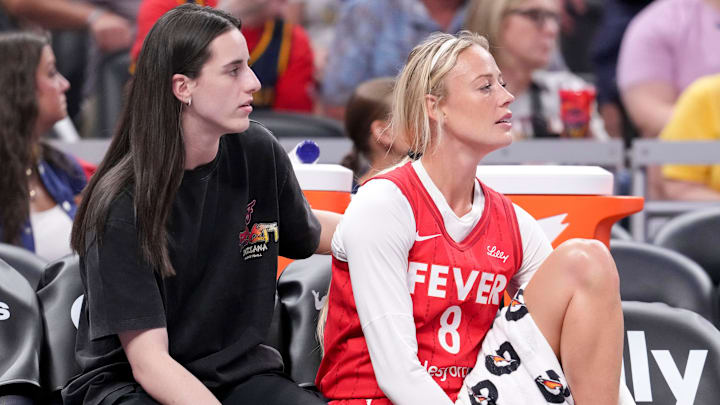 Indiana Fever guard Caitlin Clark (22) and guard Sophie Cunningham (8) watch from the bench during the first half of a game against the Washington Mystics on Friday, Aug. 15, 2025, at Gainbridge Fieldhouse in Indianapolis.