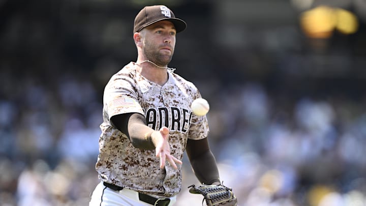 Jason Adam (40) tosses the ball to first base during the sixth inning against the St. Louis Cardinals at Petco Park. Jason Adam (40) tosses the ball to first base during the sixth inning against the St. Louis Cardinals at Petco Park.