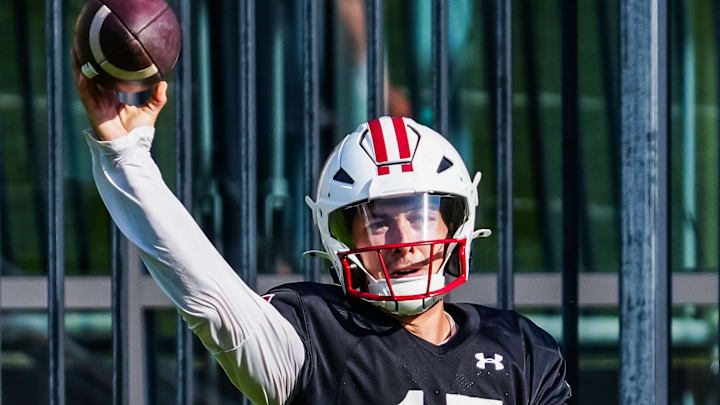 Wisconsin quarterback Cole LaCrue (17) throws a pass during football practice Wednesday, August 14, 2024 in Madison, Wisconsin.