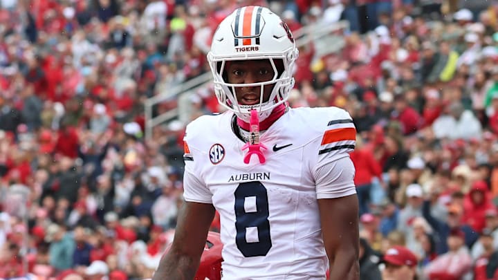 Auburn Tigers wide receiver Cam Coleman celebrates after scoring a touchdown defended by Arkansas Razorbacks defensive back Julian Neal during the first quarter at Donald W. Reynolds Razorback Stadium. 