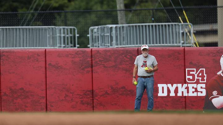 Alabama fan George Harris shags balls in the outfield at a practice at Rhoads Stadium Alabama fan George Harris shags balls in the outfield at a practice at Rhoads Stadium
