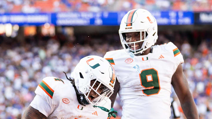 Aug 31, 2024; Gainesville, Florida, USA; Miami Hurricanes running back Mark Fletcher Jr. (4) and Miami Hurricanes tight end Elija Lofton (9) celebrate after a touchdown against the Florida Gators during the second half at Ben Hill Griffin Stadium. Mandatory Credit: Matt Pendleton-Imagn Images