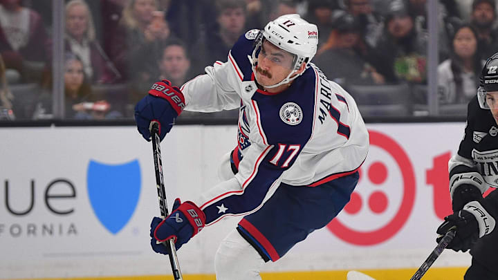 Dec 22, 2025; Los Angeles, California, USA; Columbus Blue Jackets left wing Mason Marchment (17) scores a goal ahead of Los Angeles Kings left wing Trevor Moore (12) during the first period at Crypto.com Arena. Mandatory Credit: Gary A. Vasquez-Imagn Images